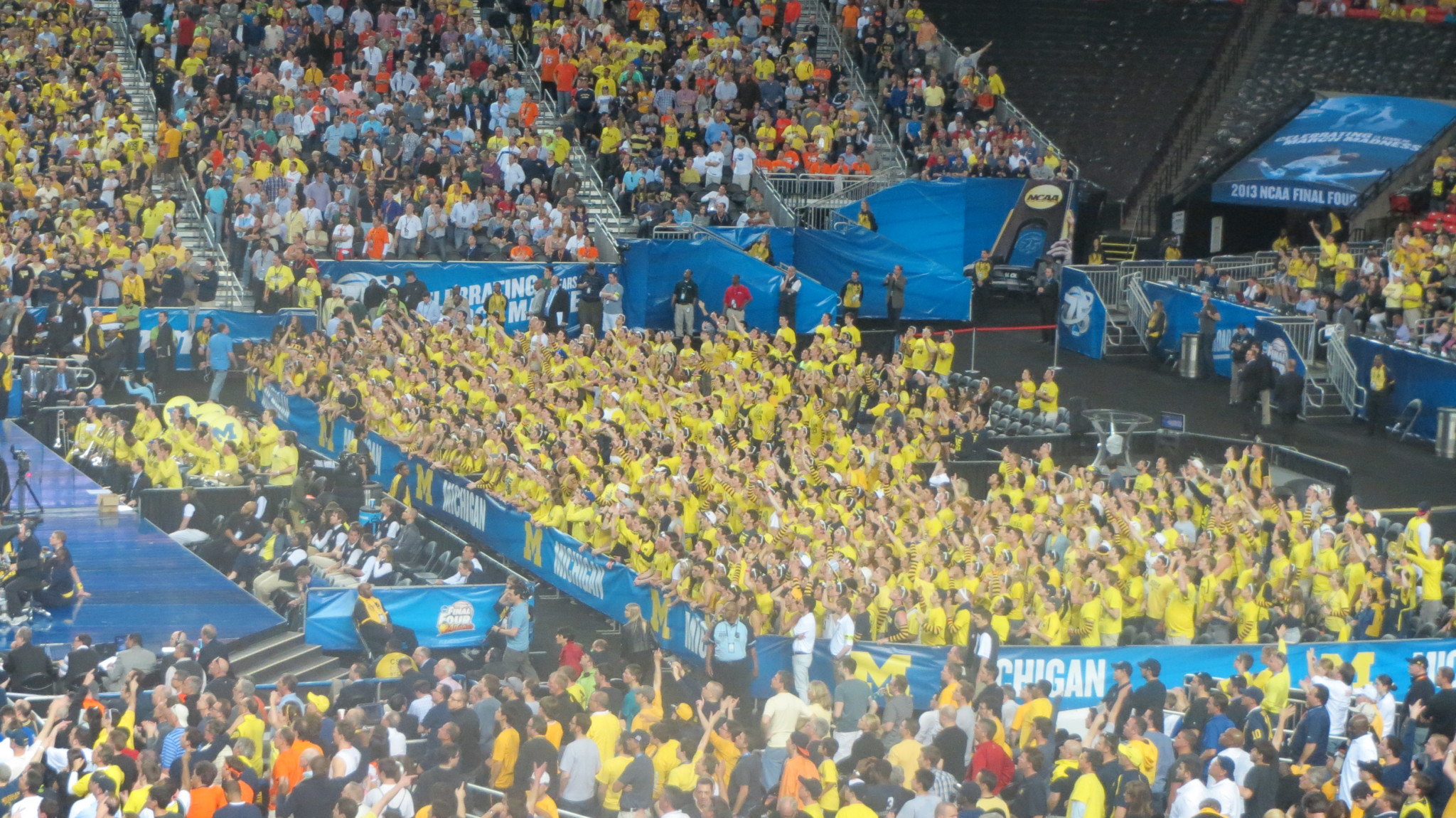 a crowd of people in yellow shirts