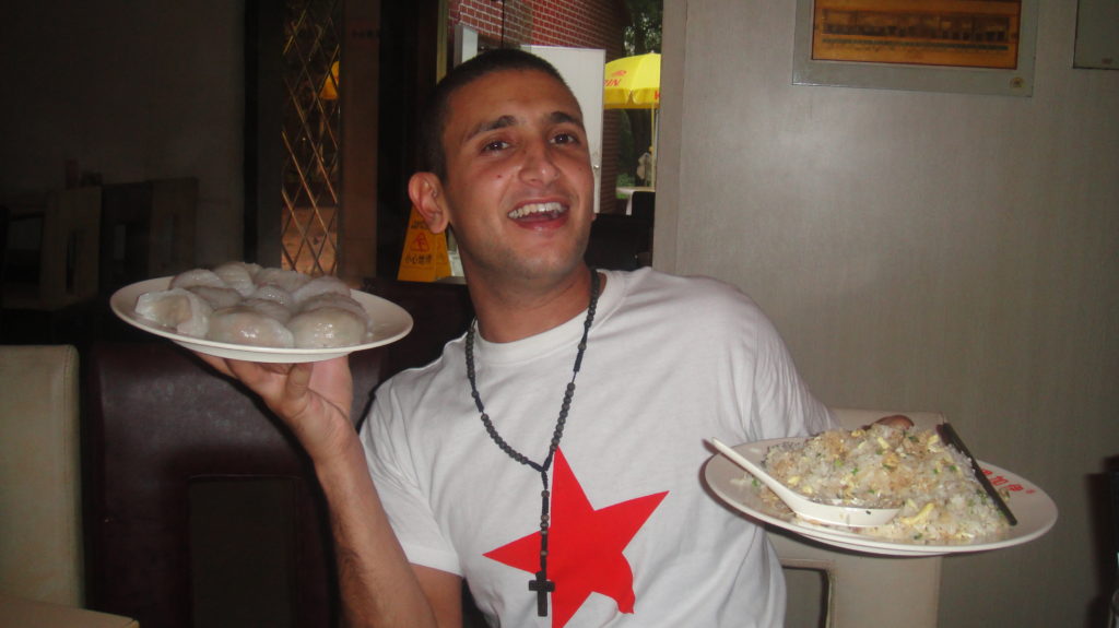 a man holding plates of food