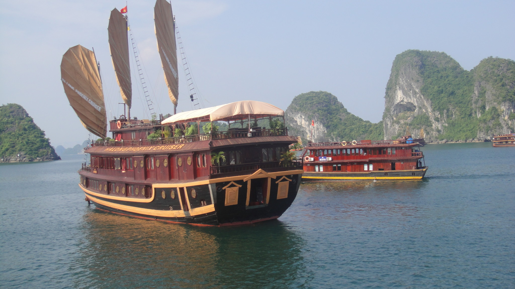 a boat on the water with Ha Long Bay in the background
