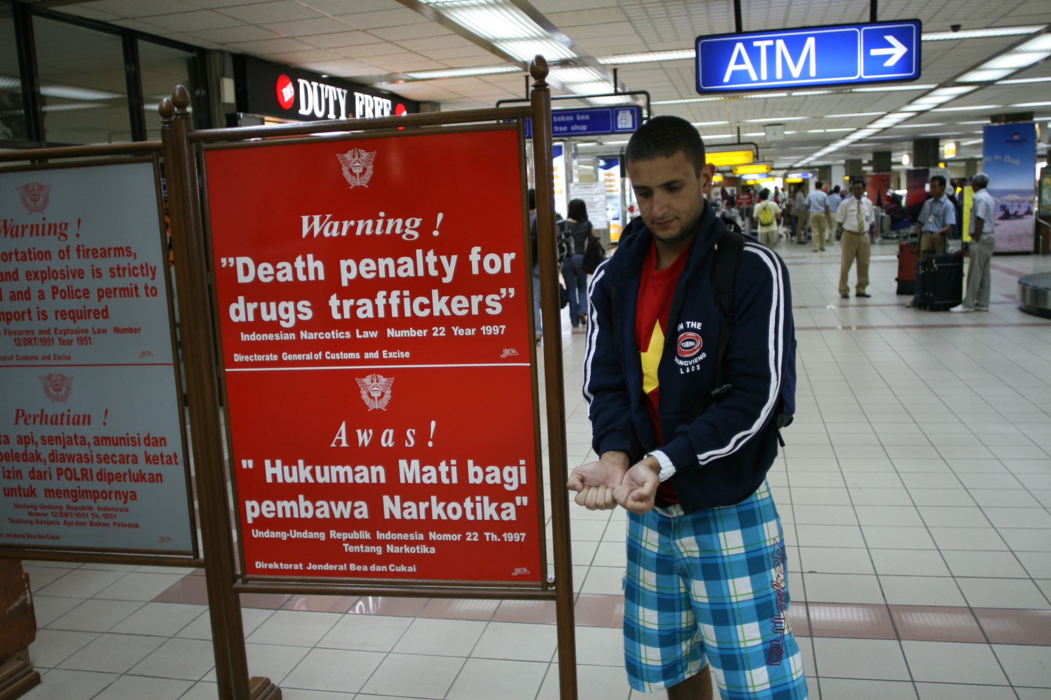 a man standing next to a sign