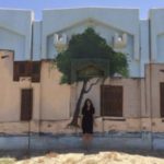 Woman standing in front of wall art in Kuwait