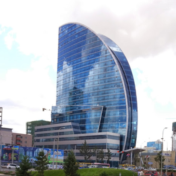 a building with a curved glass facade