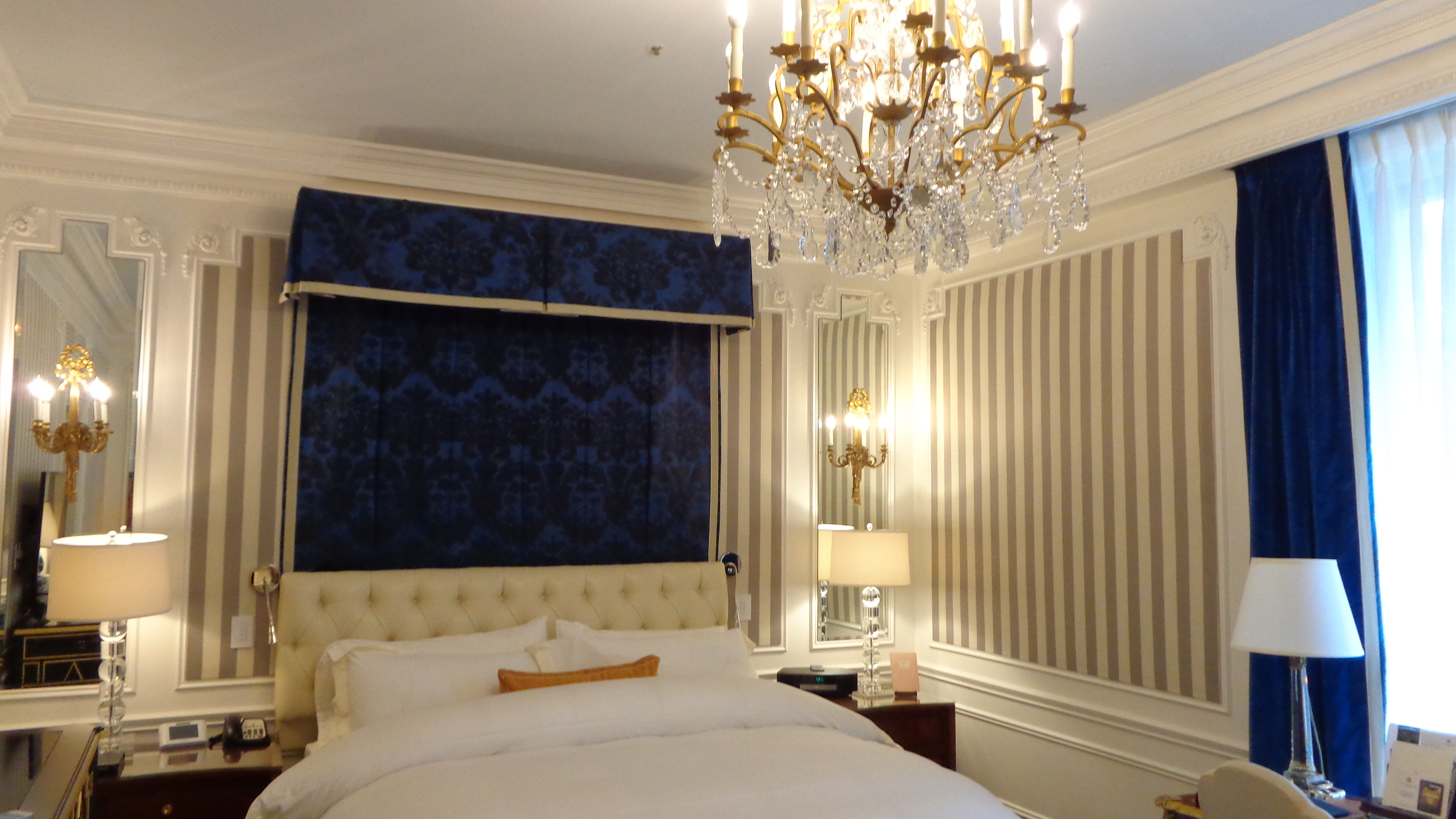 a bed with a chandelier in a room