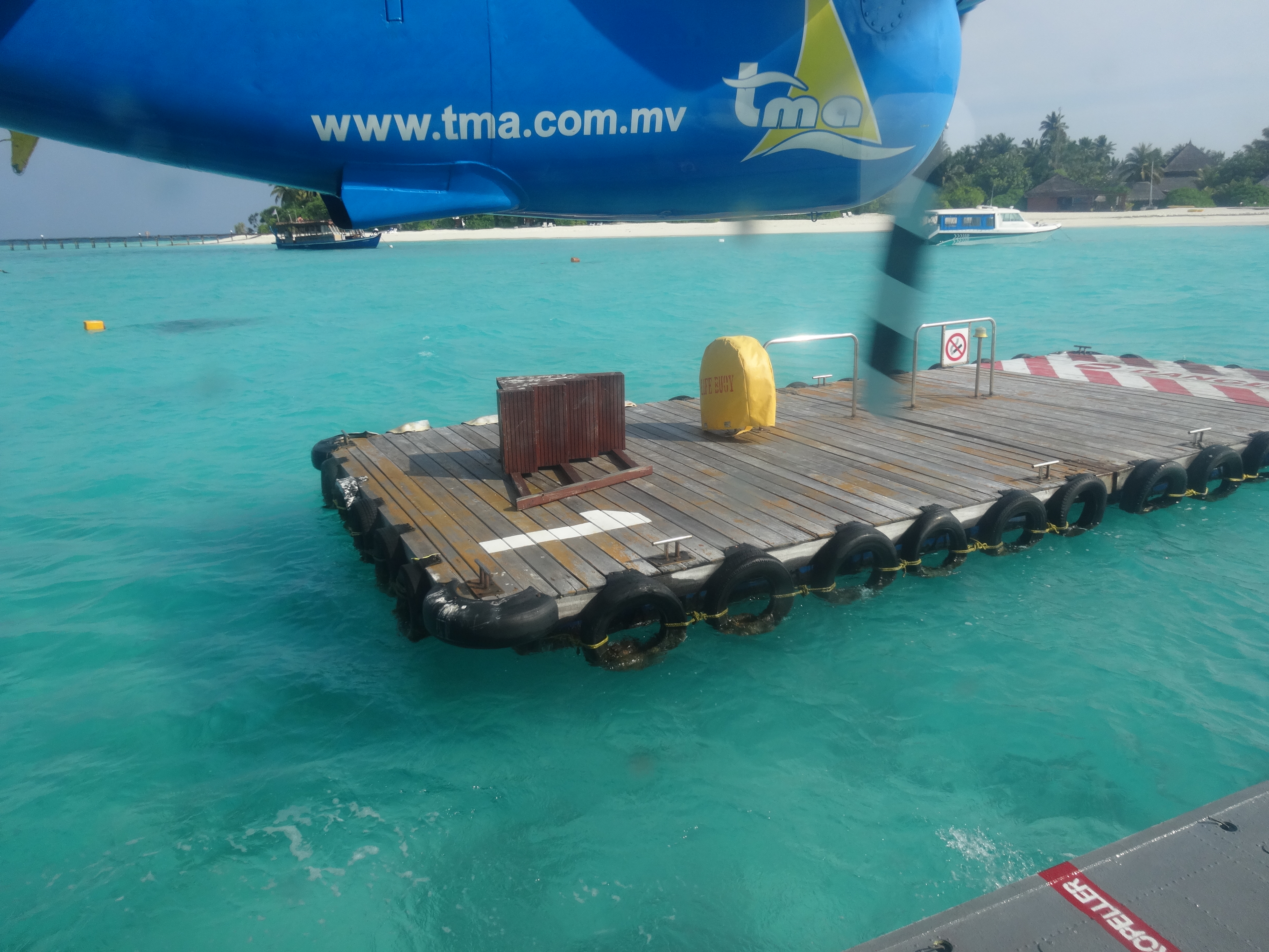 a floating dock with a plane in the background