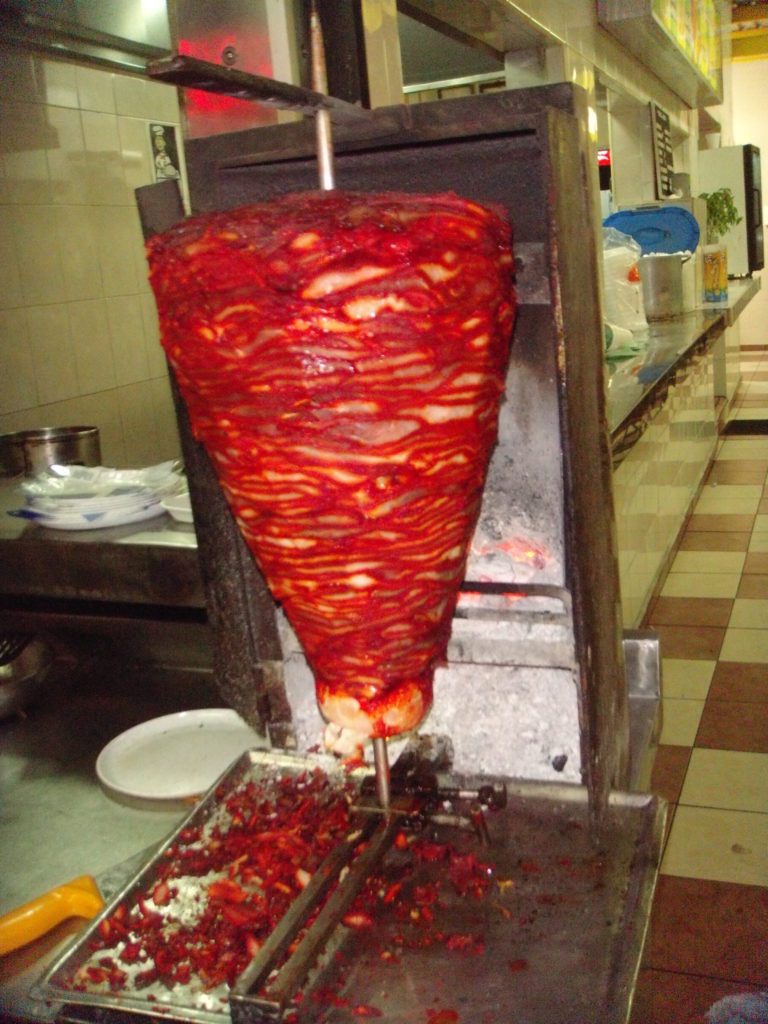 a large shawarma being cooked
