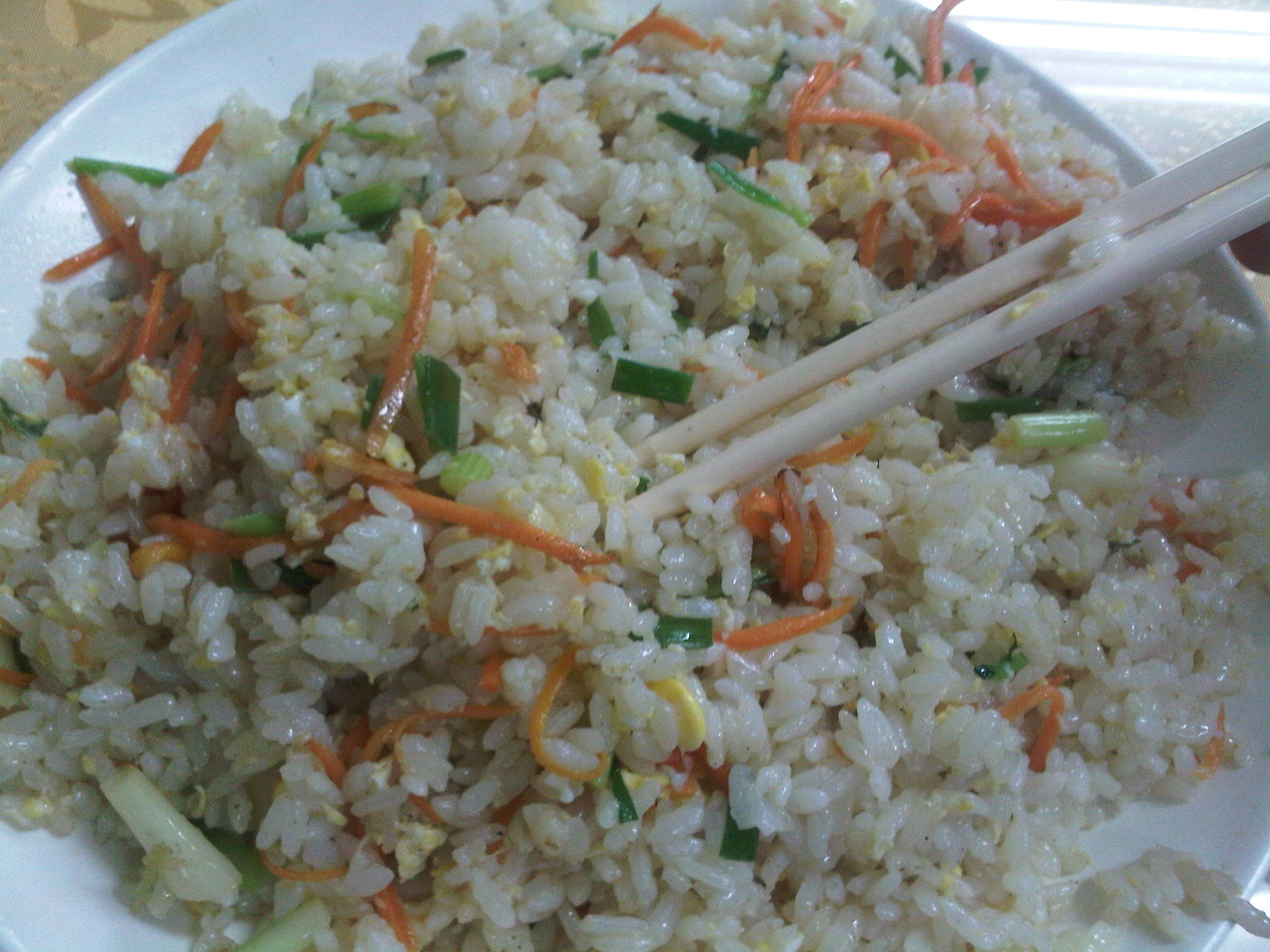 a bowl of rice with chopsticks