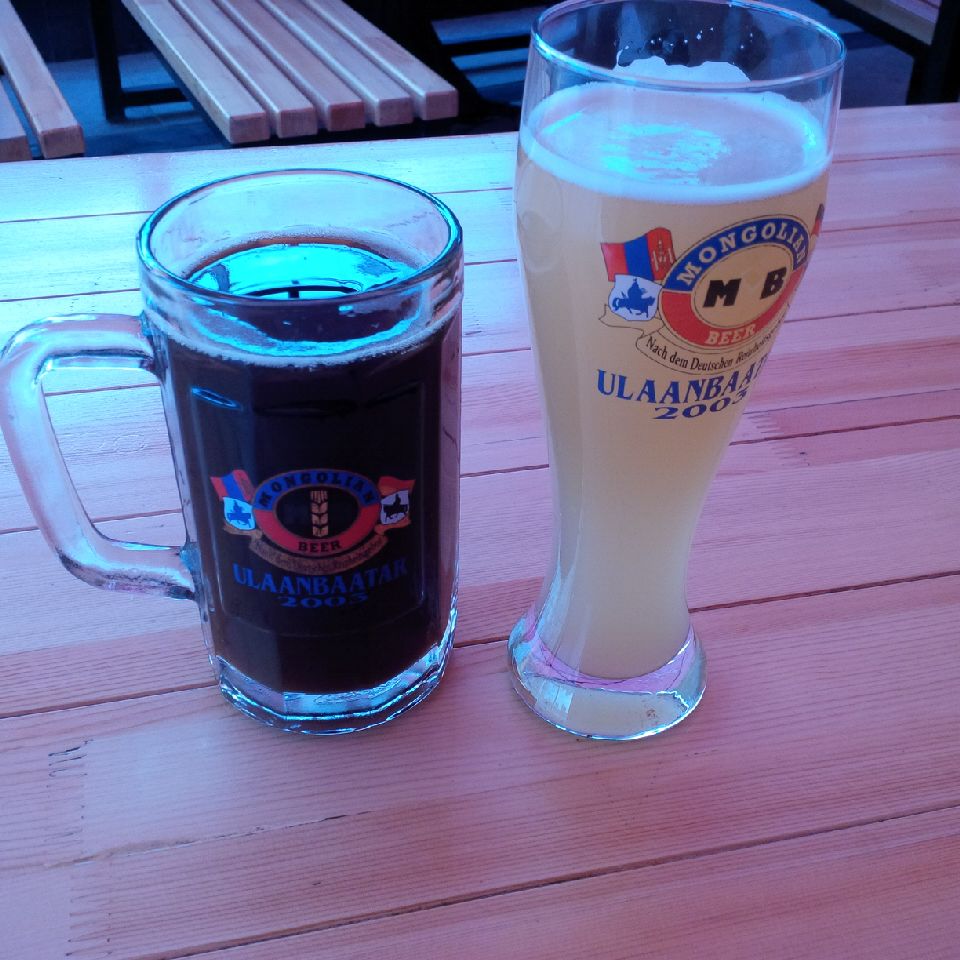 a glass of beer next to a glass of beer
