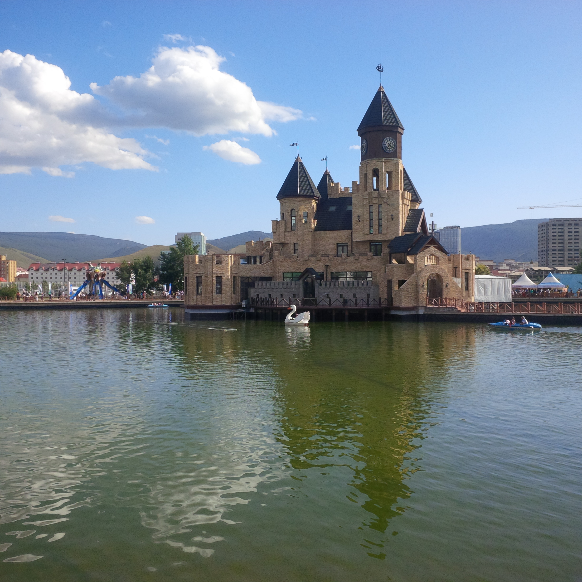 a castle with a clock tower on the water