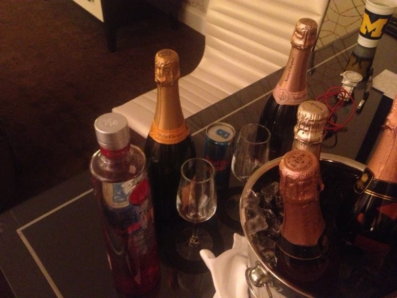 a group of bottles of champagne and glasses on a table