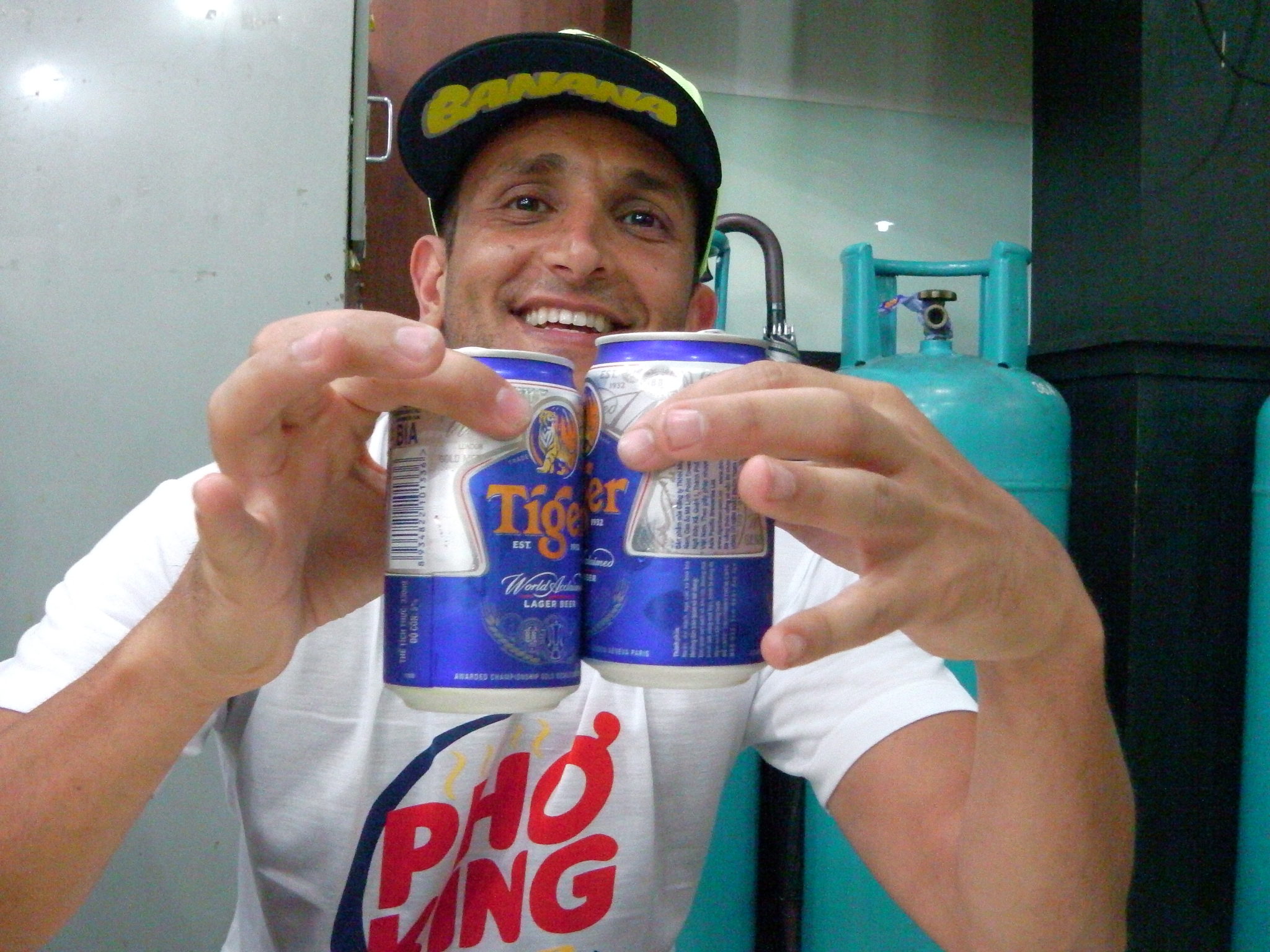 a man holding up two cans