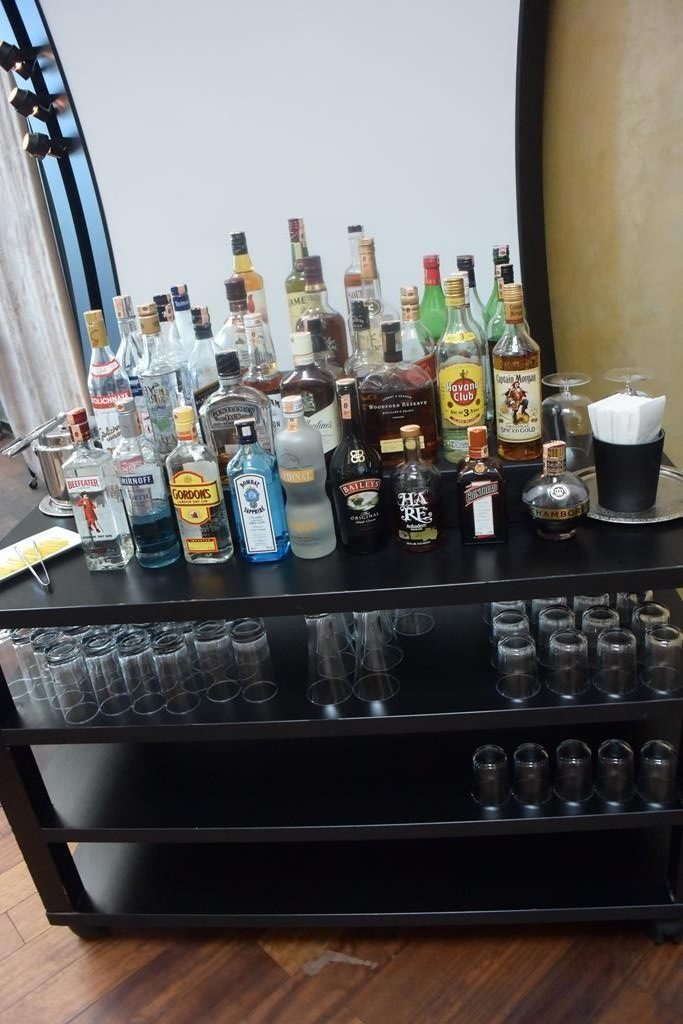a shelf with many bottles and glasses