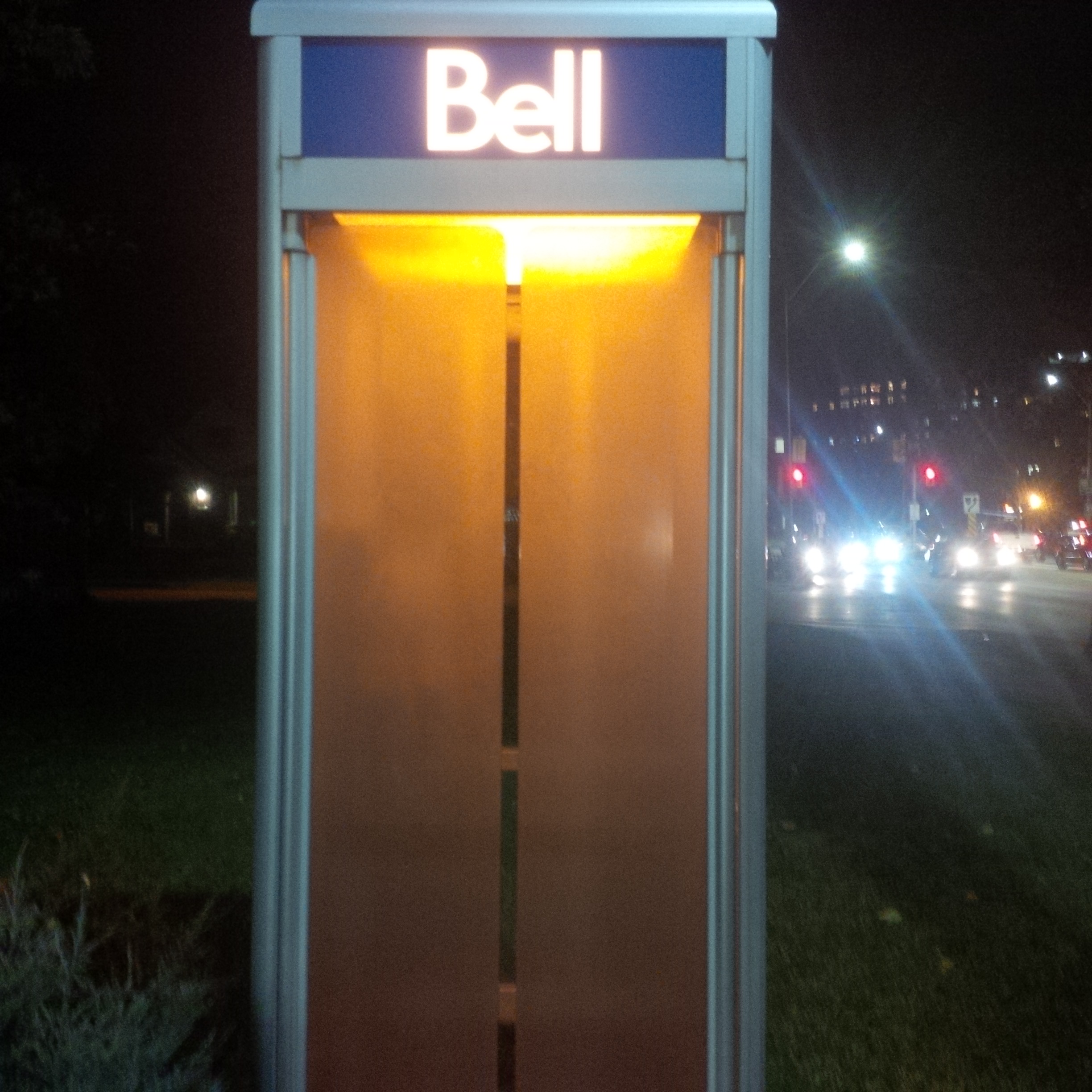 a phone booth with a light in the middle of it