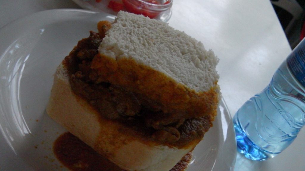 bunny chow! curry lamb within bread and u eat the bread at the same time