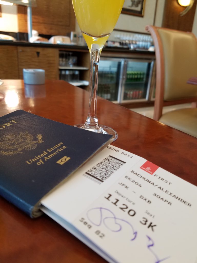 a passport and a glass of liquid on a table