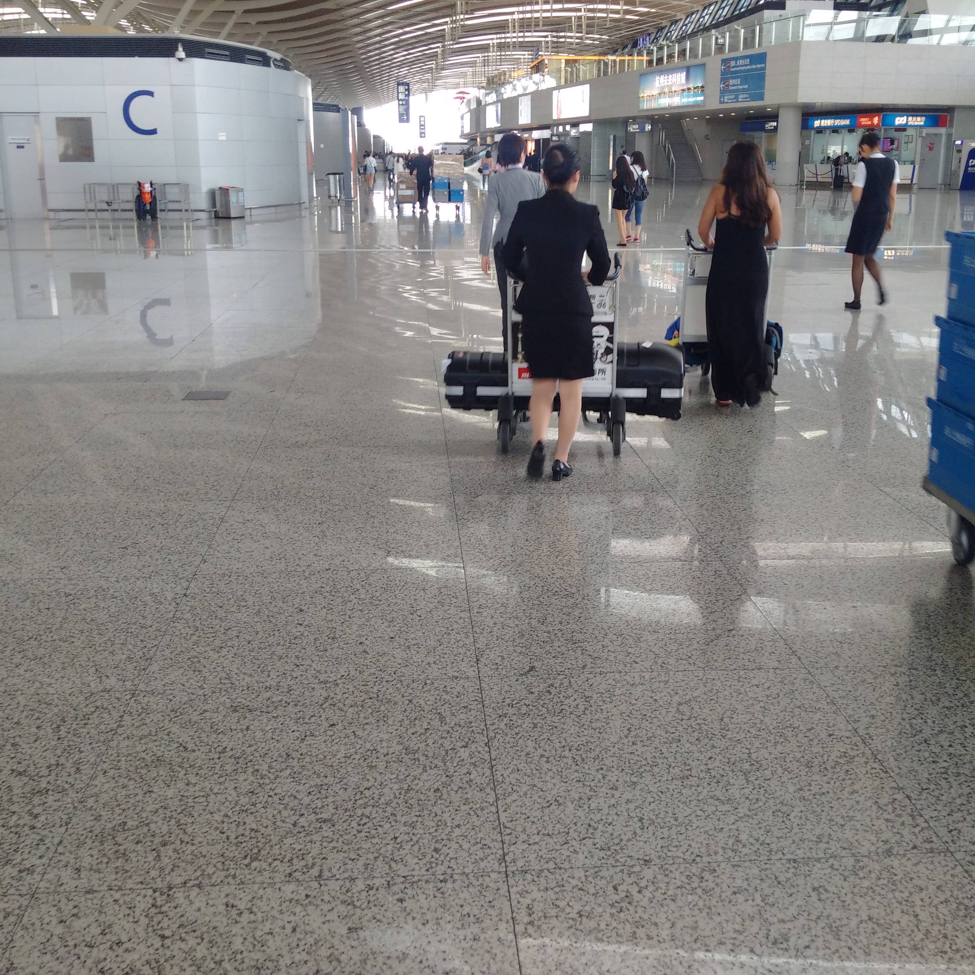 people in an airport with luggage