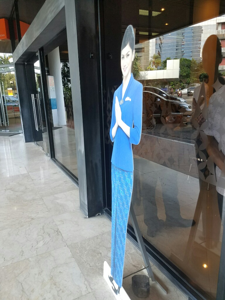 a cardboard cutout of a woman in a blue suit