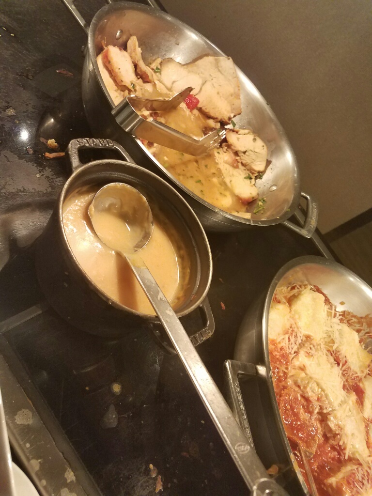 a group of pots with food in them