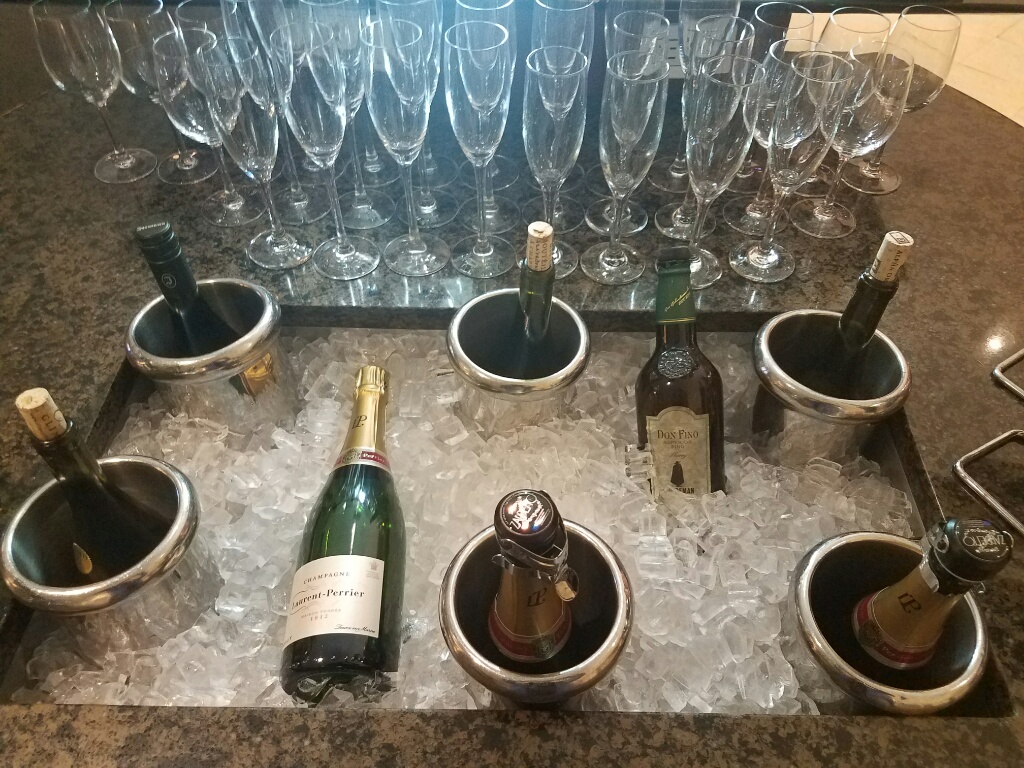 a group of wine bottles in ice buckets