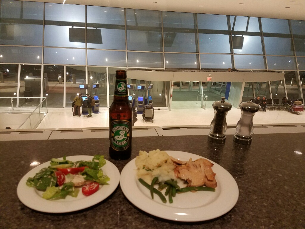 a plate of food and beer on a counter