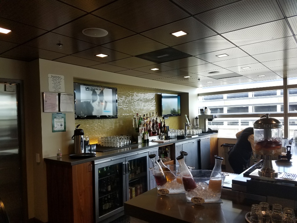 a bar with a television and bottles