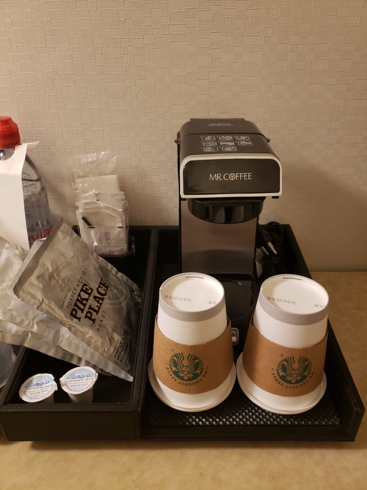a coffee machine and coffee cups on a tray