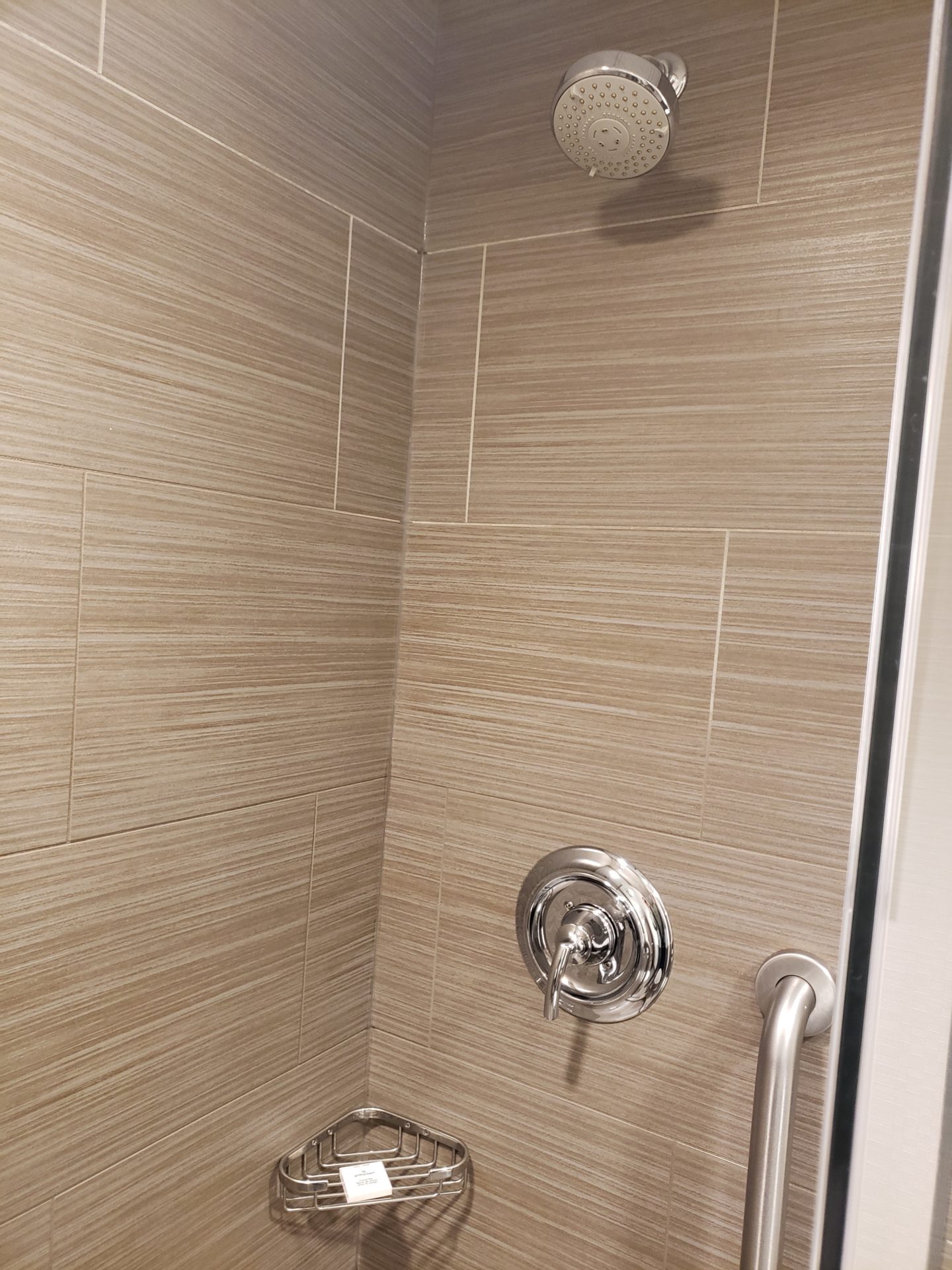 a shower with a shower head and a hand shower