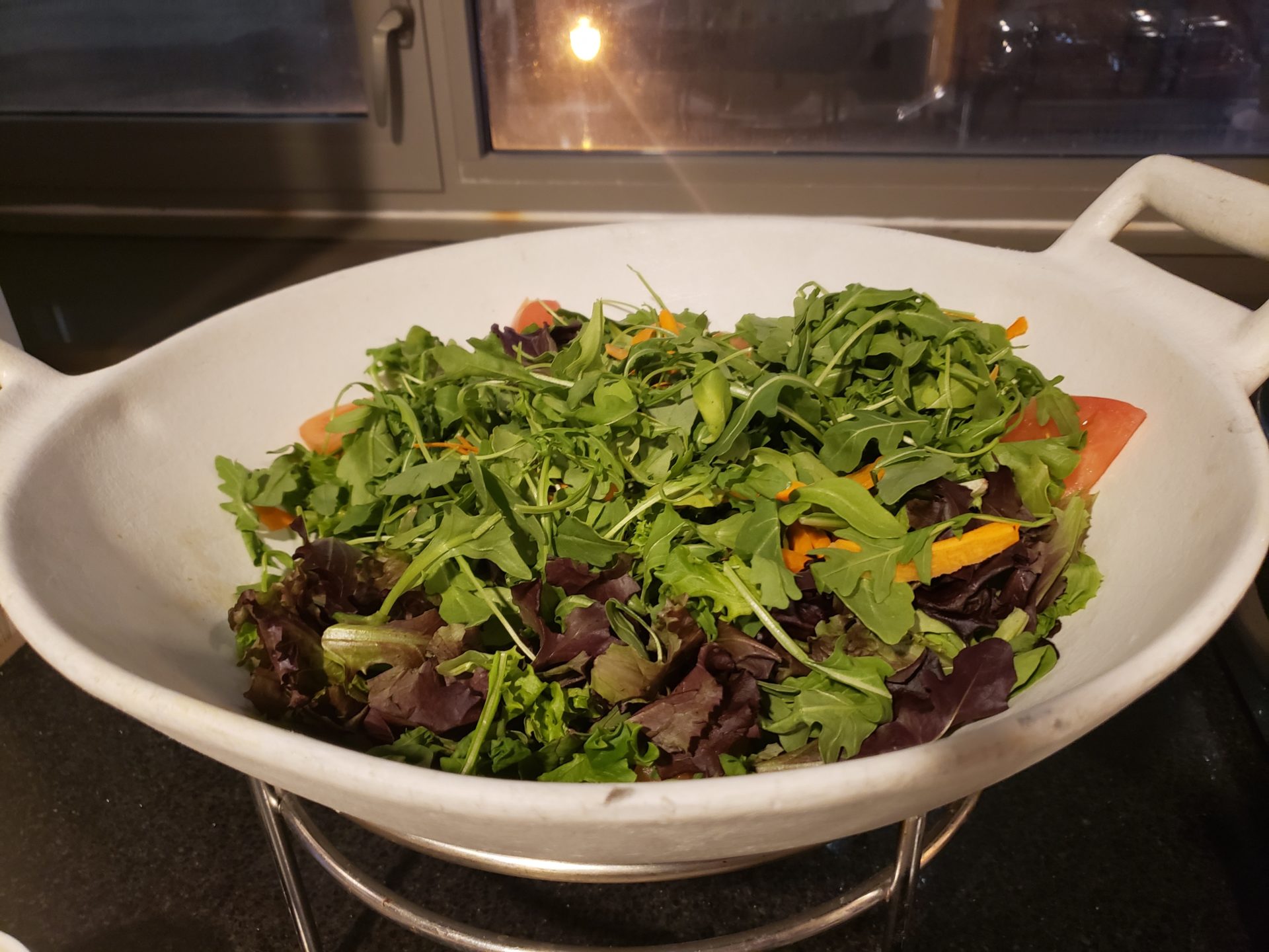 a bowl of salad in a kitchen