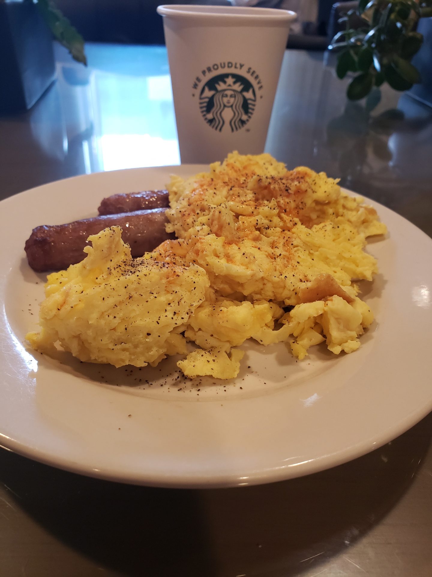 a plate of scrambled eggs and sausages