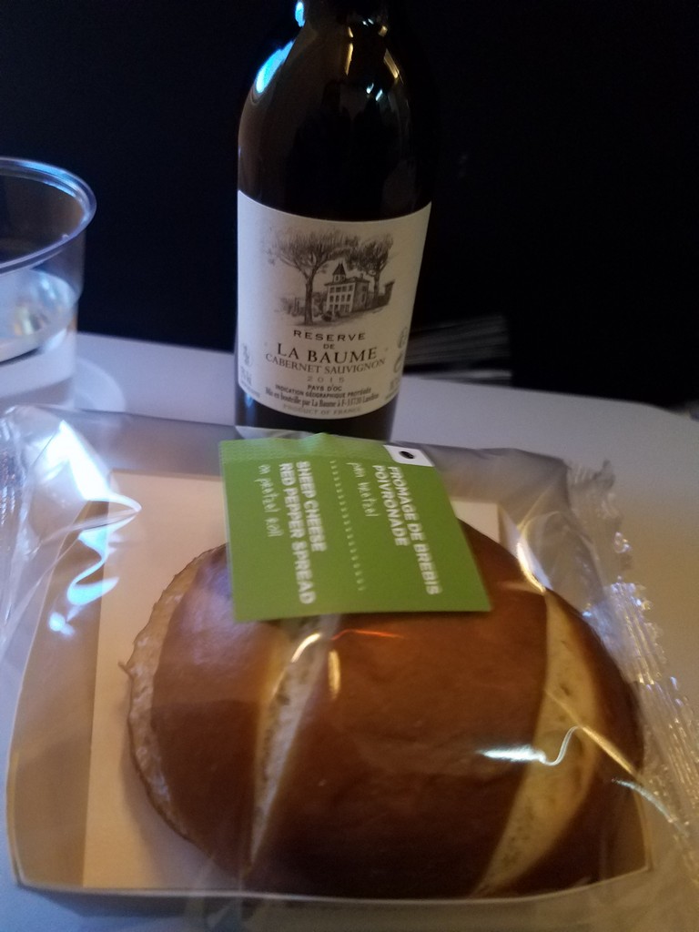 a roll of bread and a bottle of wine