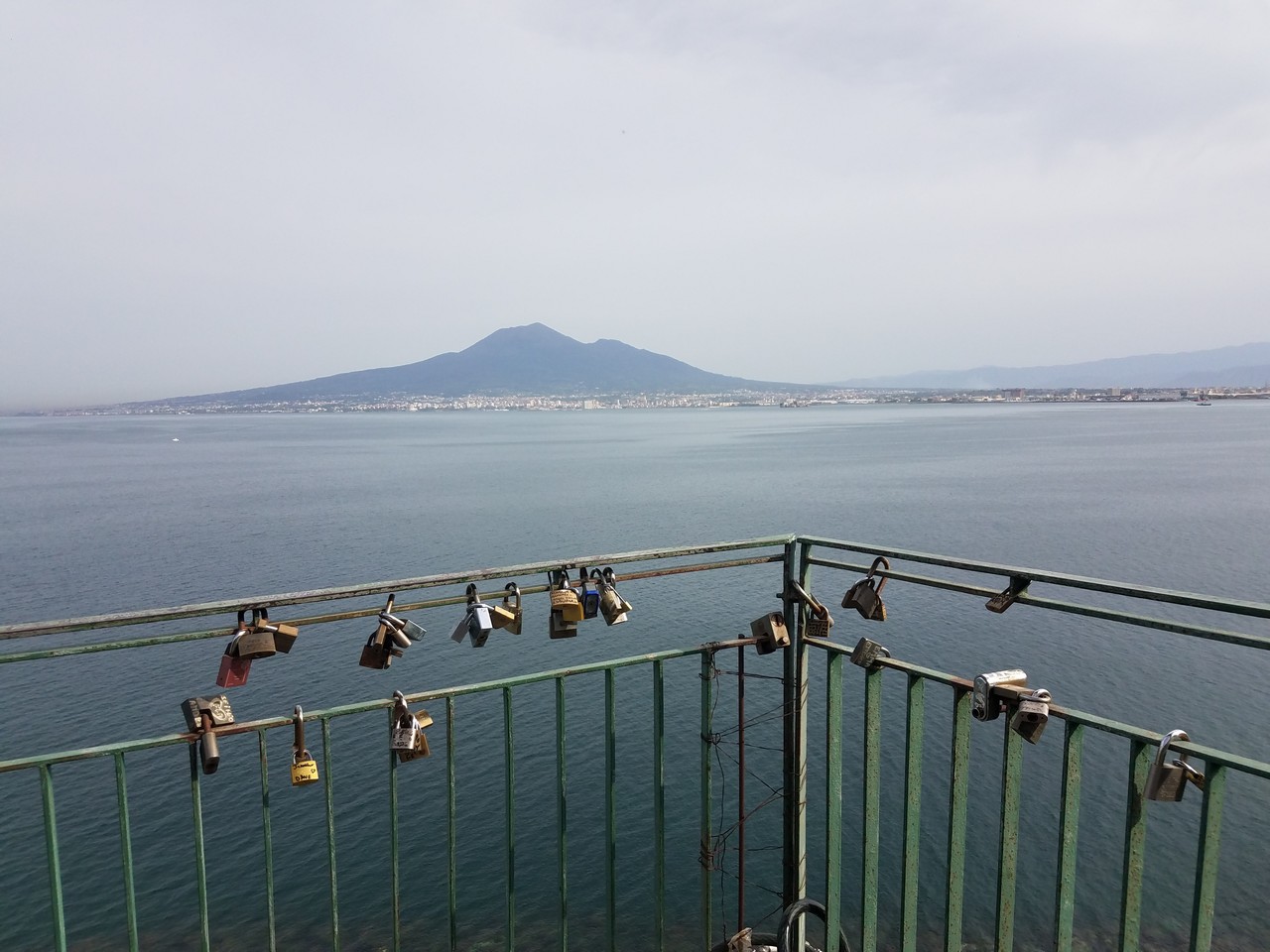 a bridge with locks on railing over water