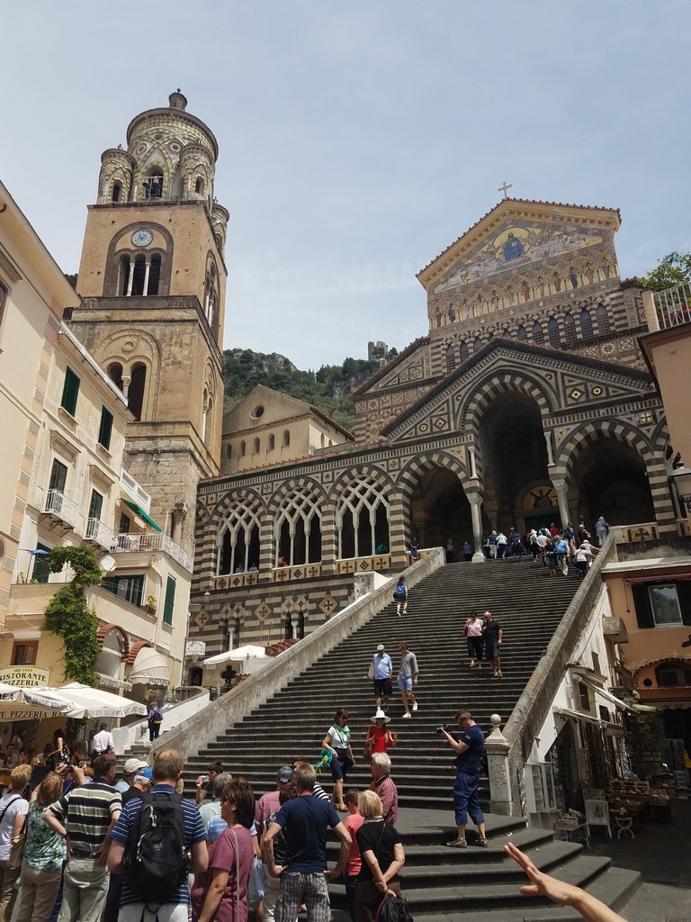 a group of people walking up stairs in Amalfi