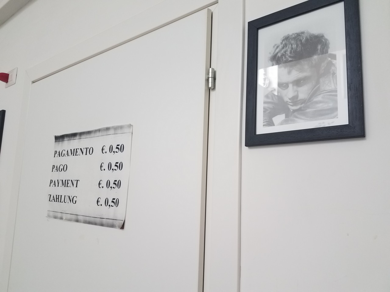 a picture of a man in a black frame on a white wall