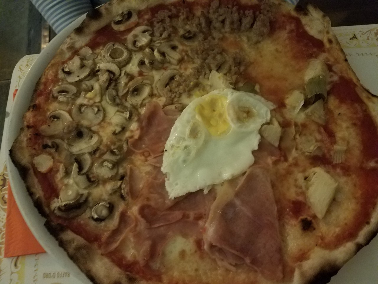 a pizza with egg and ham