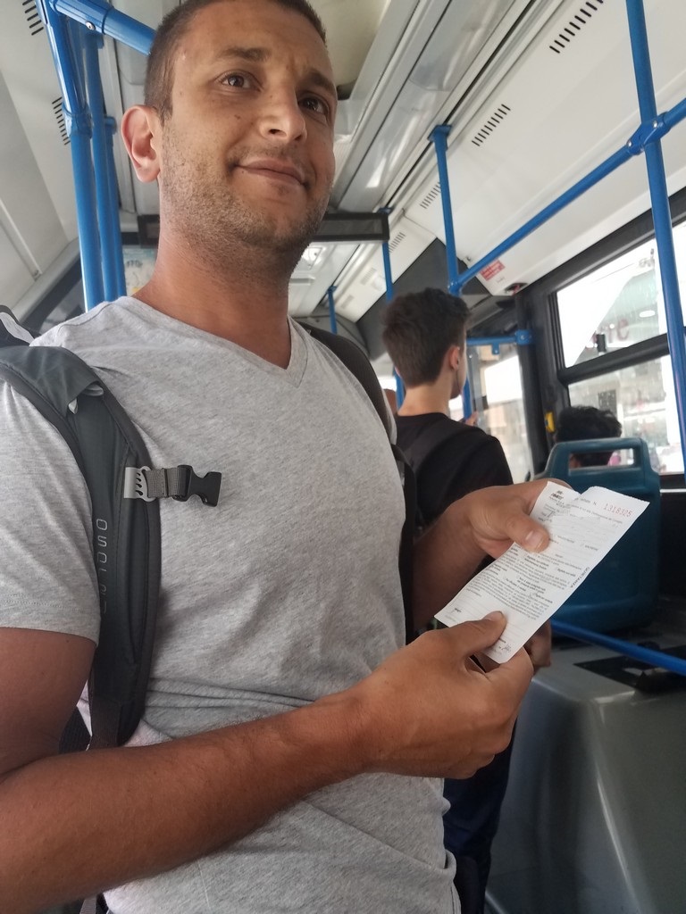 a man holding a paper in a bus