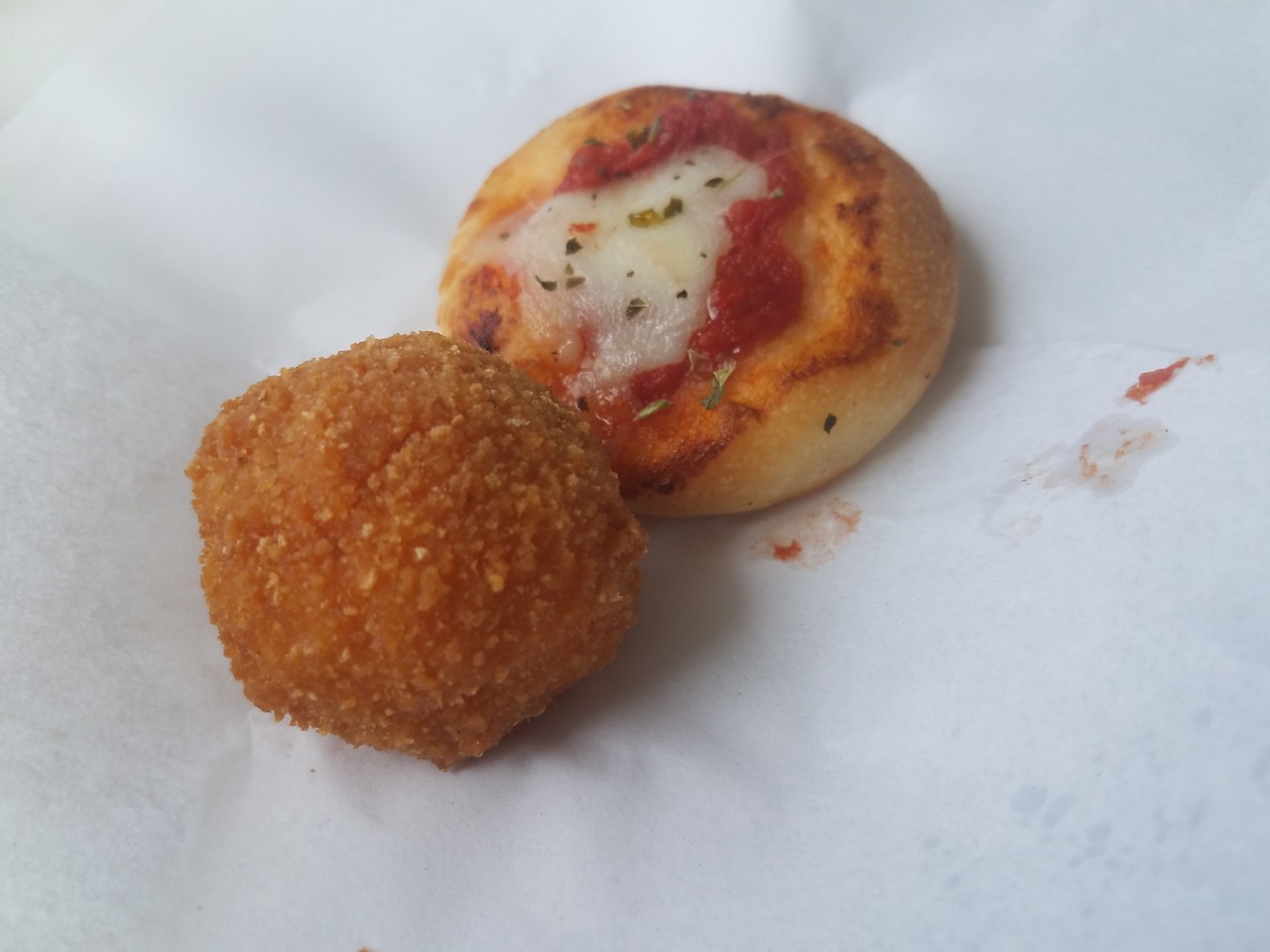 a small pizza and a round pizza ball