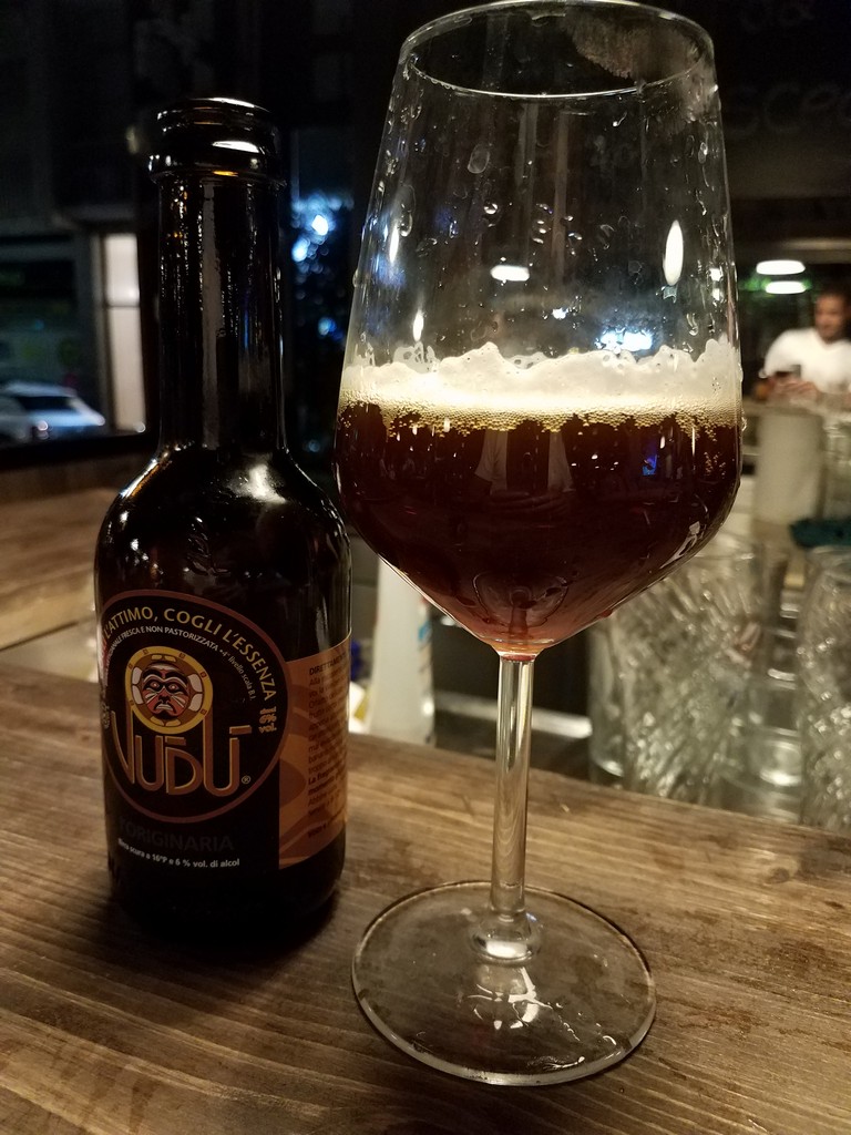 a glass of beer next to a bottle