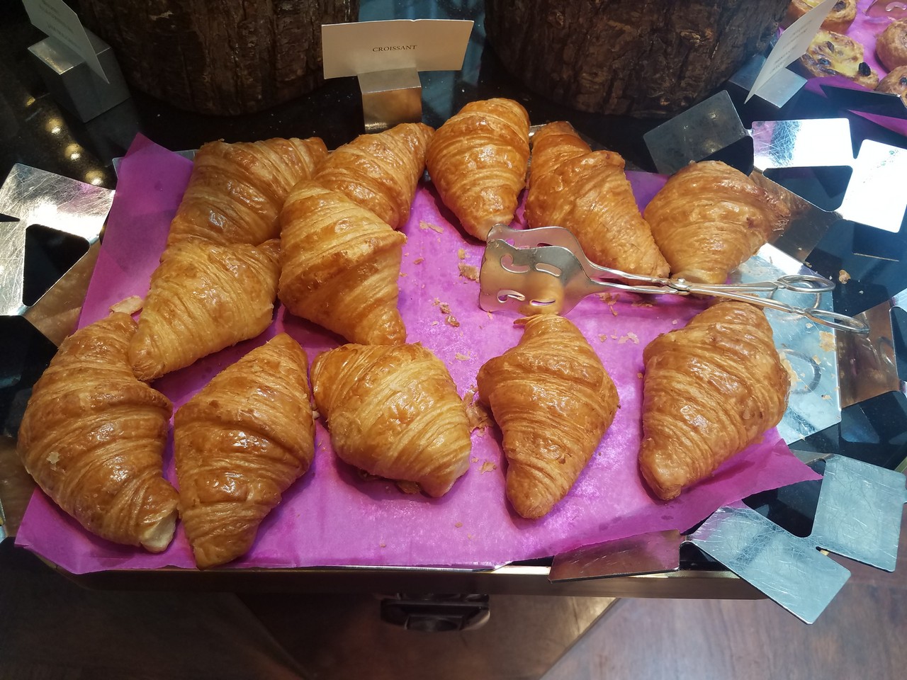 a tray of croissants on a table