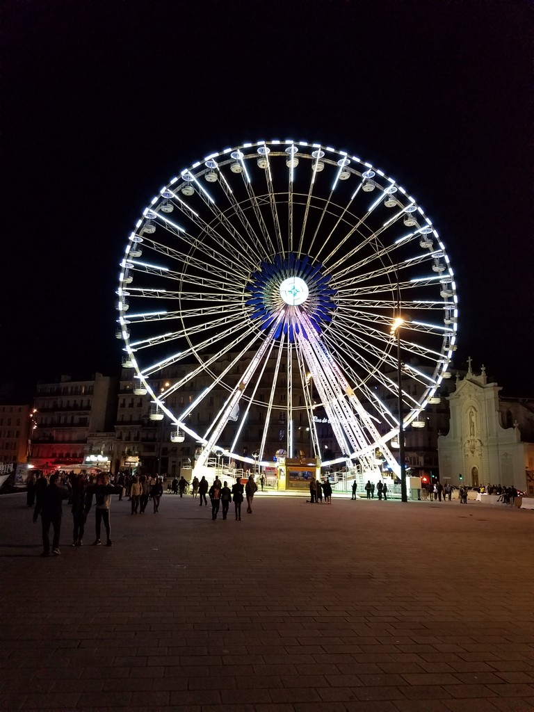 a large ferris wheel with lights at night