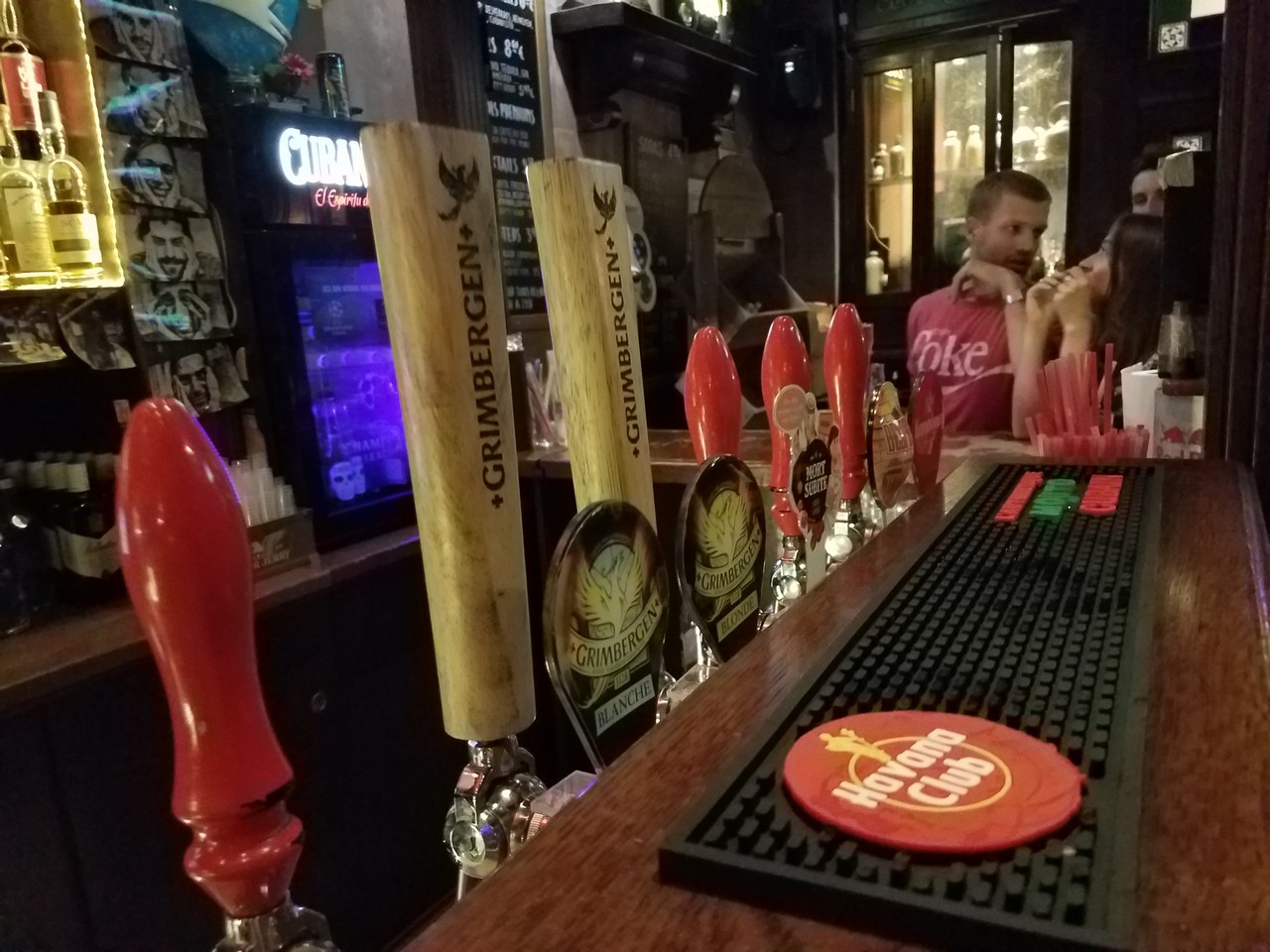 a bar with a row of beer taps