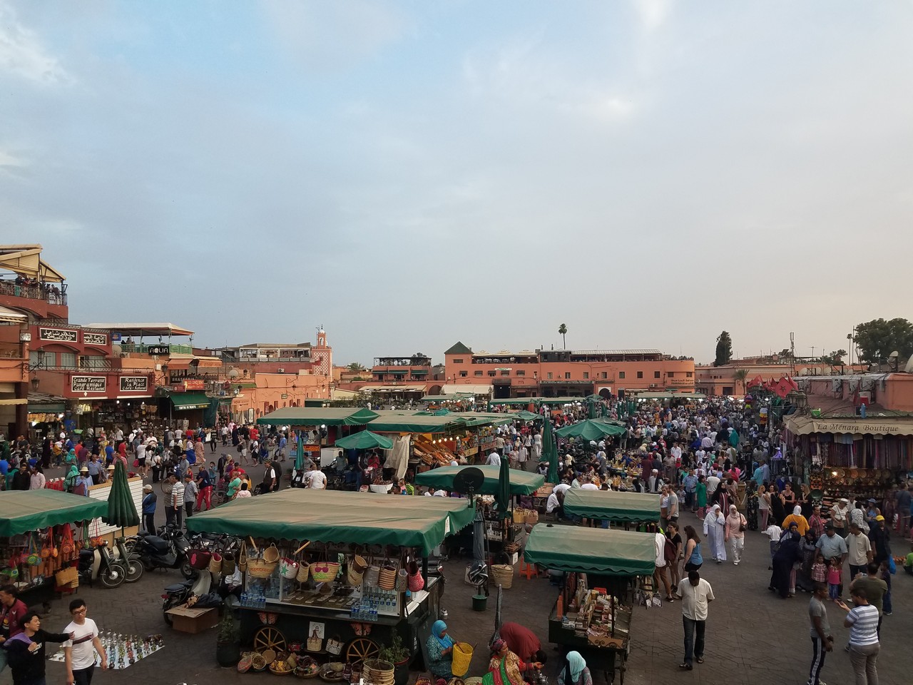 a crowd of people in a square with tents