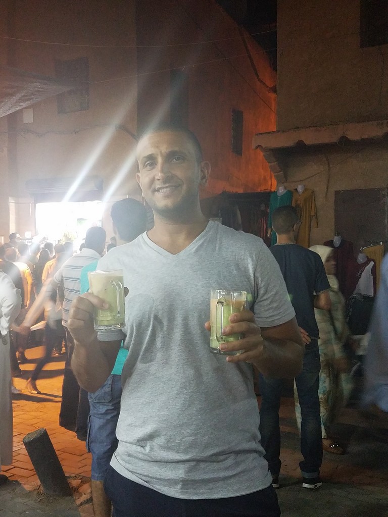 a man holding two glasses of beer