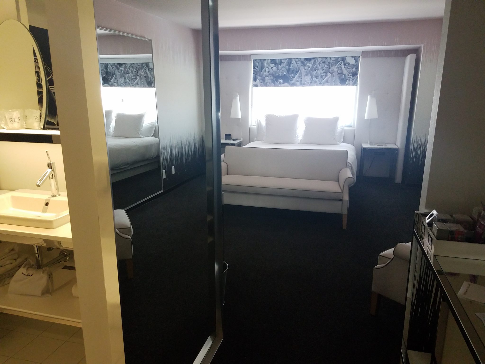 a room with a bed and a mirror
