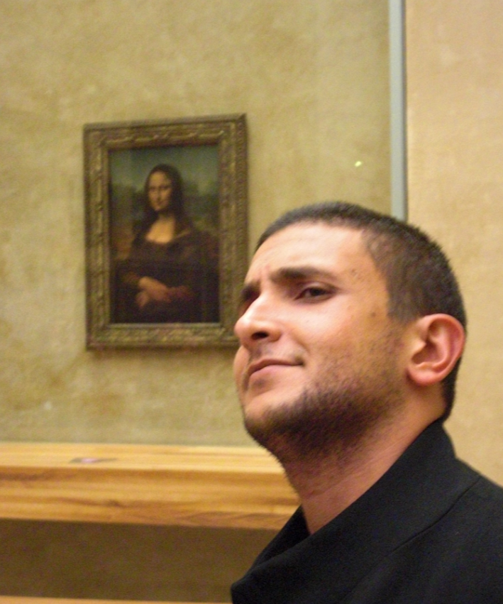 a man looking up at a painting