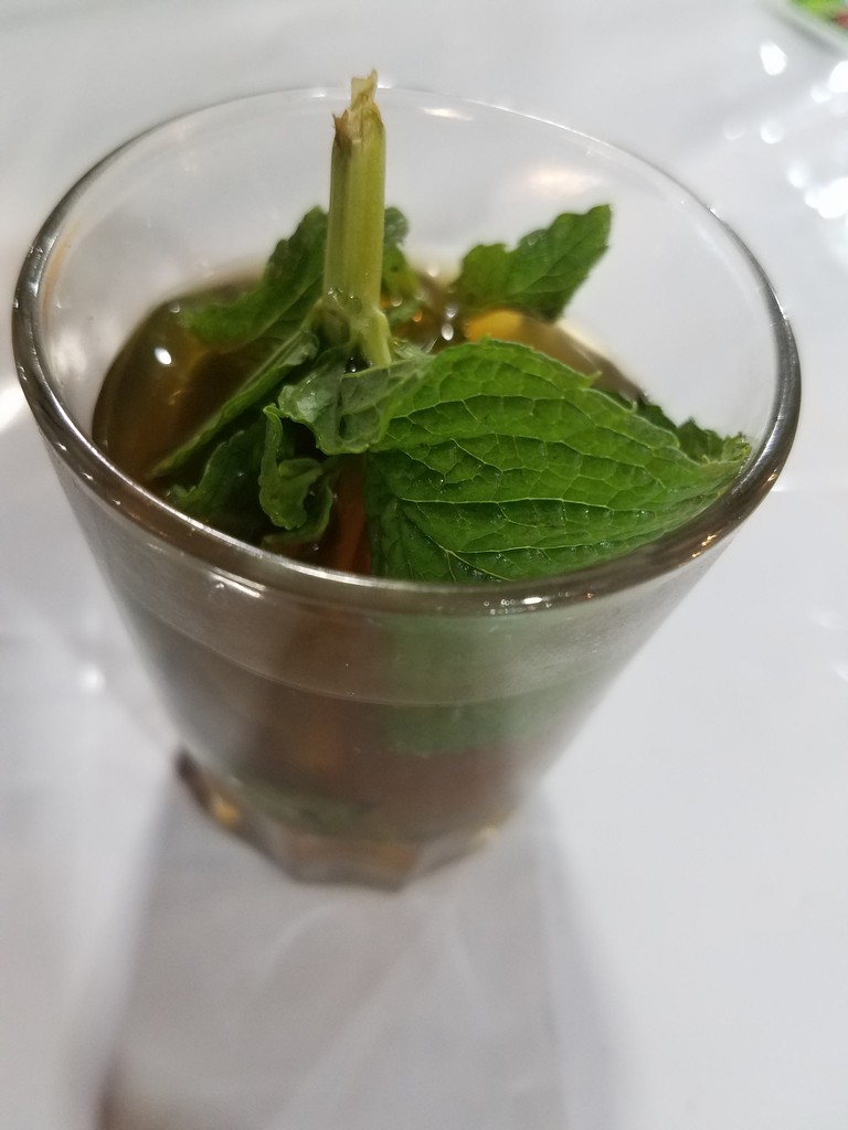 a glass with a plant in it