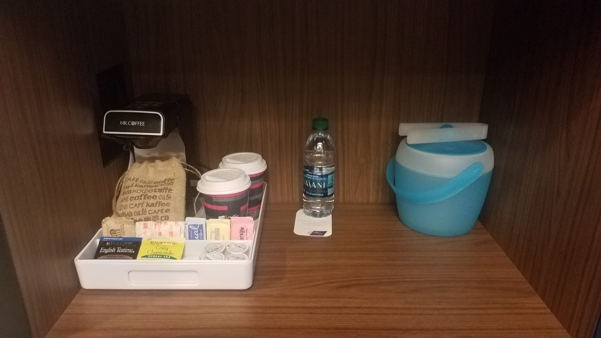 a tray of coffee and a water bottle on a table