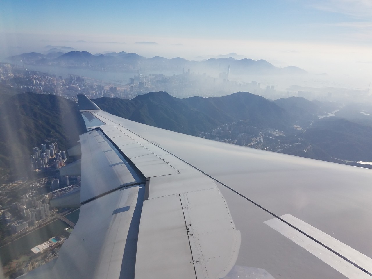an airplane wing and city in the air
