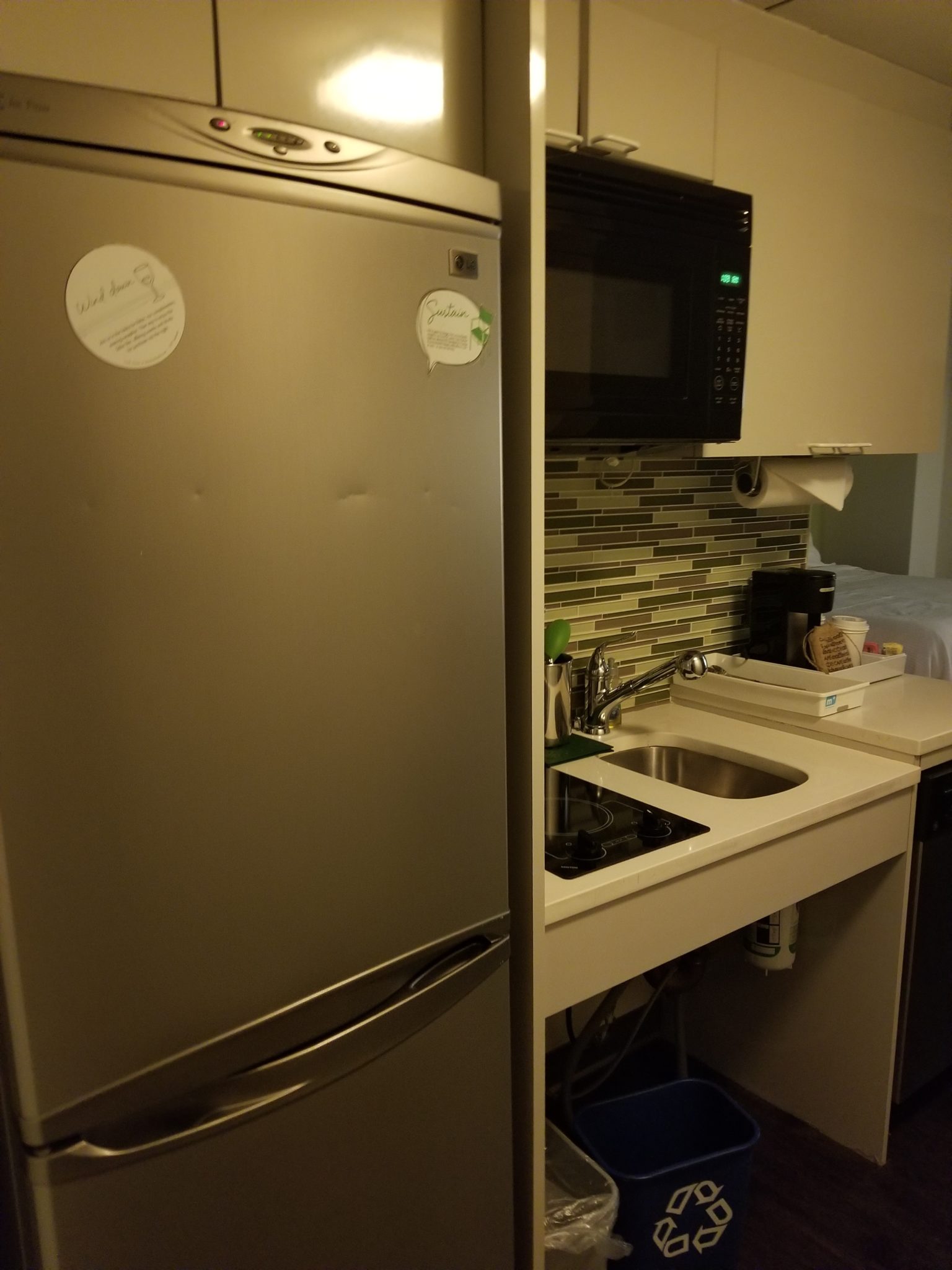 a kitchen with a microwave and a refrigerator