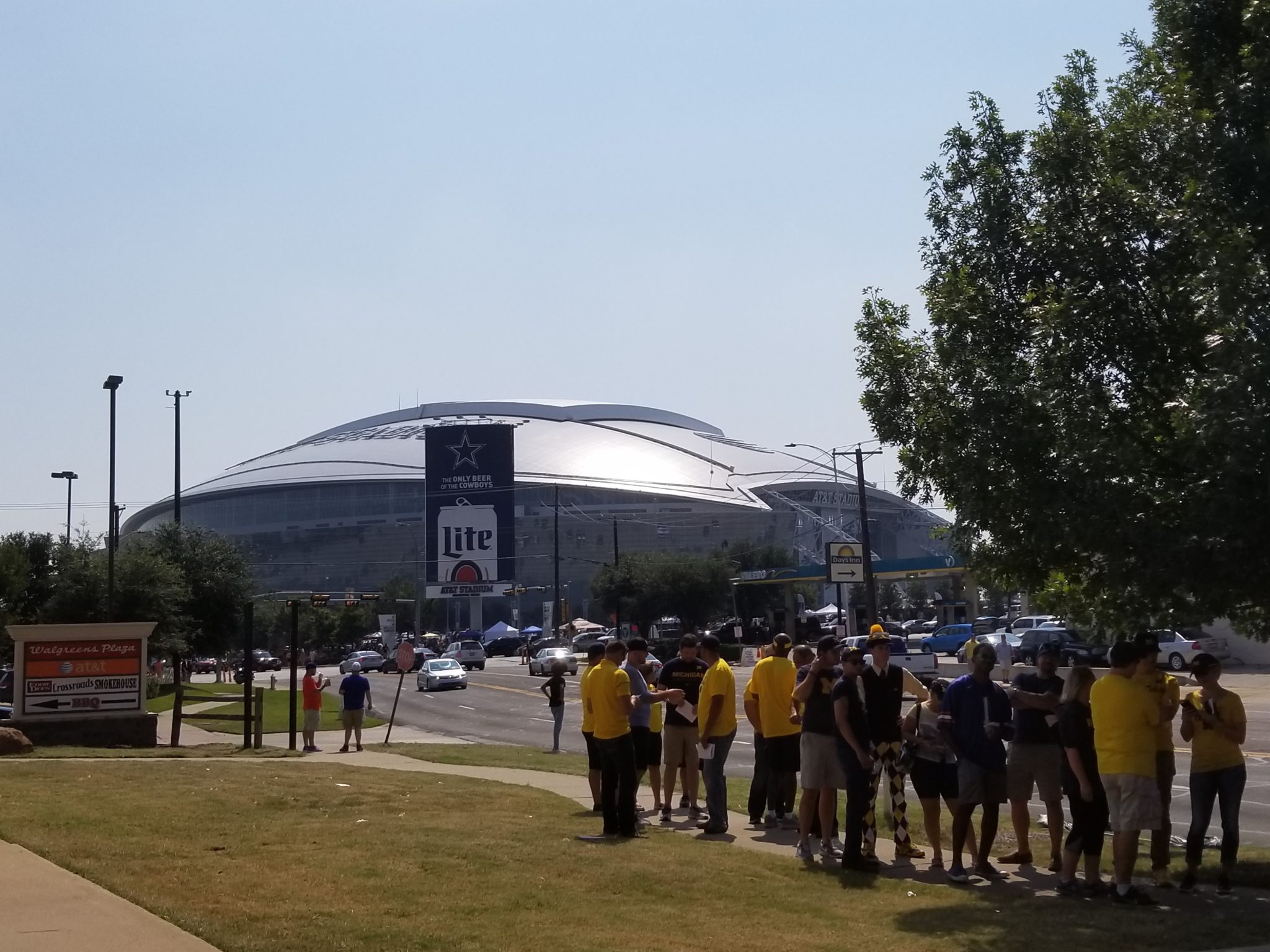 a group of people standing in front of a stadium