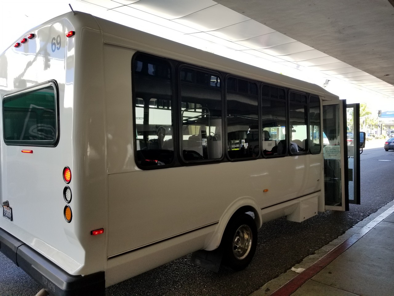 a white bus parked at a bus stop
