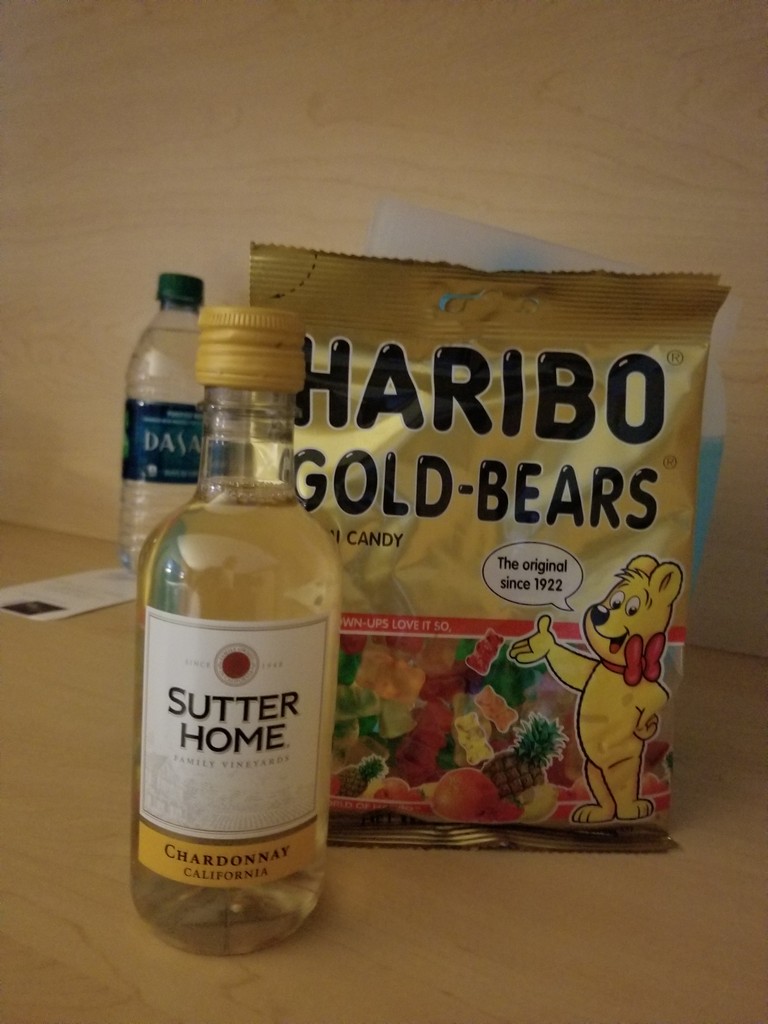 a bottle of liquor next to a bag of candy